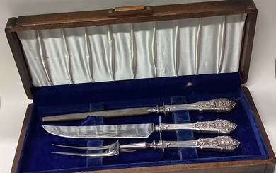 A cased Continental silver three piece carving set.