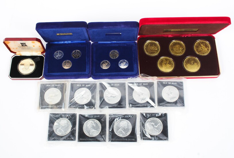 A collection of Isle of Man commemorative silver and white metal coin sets to include crowns and