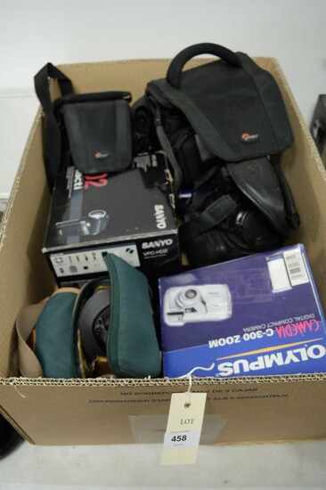 A collection of digital cameras and camera bags
