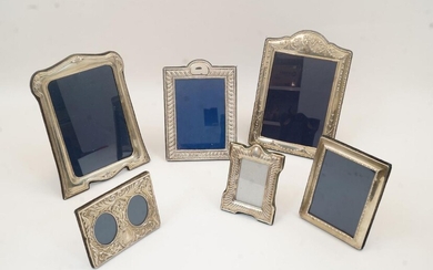 A collection of six of silver picture frames, to include: an example with foliate motifs, Sheffield, 1994, Carr's of Sheffield Ltd, 23.5cm x 18cm; another with floral swags, Carr's of Sheffield Ltd, 24.5cm x 17cm; a diptych picture frame with...