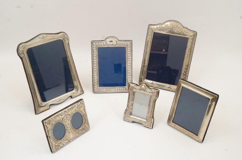 A collection of six of silver picture frames, to include: an example with foliate motifs, Sheffield, 1994, Carr's of Sheffield Ltd, 23.5cm x 18cm; another with floral swags, Carr's of Sheffield Ltd, 24.5cm x 17cm; a diptych picture frame with...