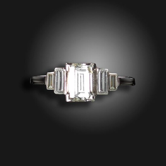 A diamond five-stone ring, centred with a baguette-shaped diamond weighing...