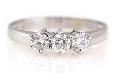 A diamond ring set with three brilliant-cut diamonds weighing a total of...