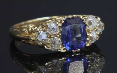 A gold sapphire and diamond carved head ring