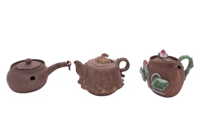 A group of three small Chinese Yixing teapots and covers one...