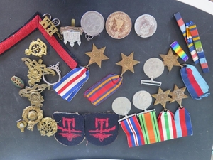 A group pf three WWII medals on a bar and four further WWII ...