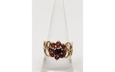 A hallmarked 9ct gold red stone daisy cluster ring, gross we...