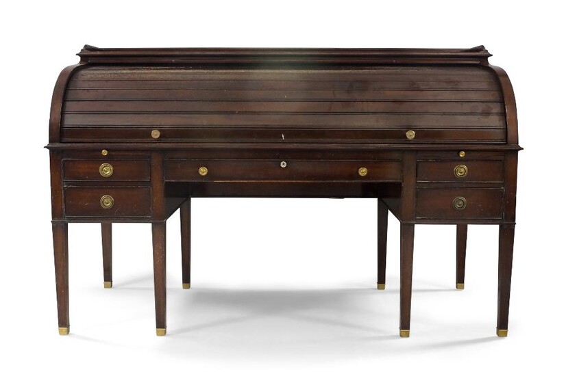 A large Regency style mahogany roll top bureau, early 20th century, ebony strung, the galleried rectangular top above tambour roll front, enclosing drawers and pigeons holes and tooled leather skiver, above five drawers and two brush slides, raised...