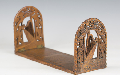 A late 19th century Irish carved oak extending bookstand, each end finely carved with a harp and ins