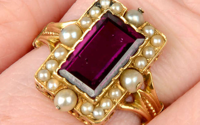 A late 19th century gold purple garnet, split and seed pearl cluster ring, with black enamel accent shoulders.