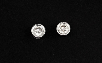 A pair of 18ct white gold (stamped 18k) rub over brilliant cut diamond set stud earrings, approx. 0.90ct overall, L. 0.5cm.
