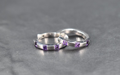 A pair of 9ct white gold hinged hoop earrings having amethyst insets, approx 5.3g