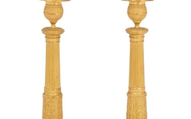 A pair of French Empire gilt-bronze candlesticks