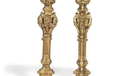 A pair of French carved giltwood torchères, 18th century. H. 156 cm. Diam. 39 cm.