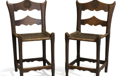 A pair of Russian Arts and Crafts oak side chairs, in the...
