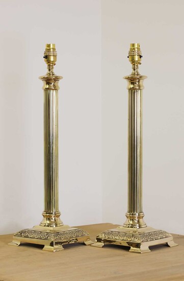 A pair of brass candlestick lamps