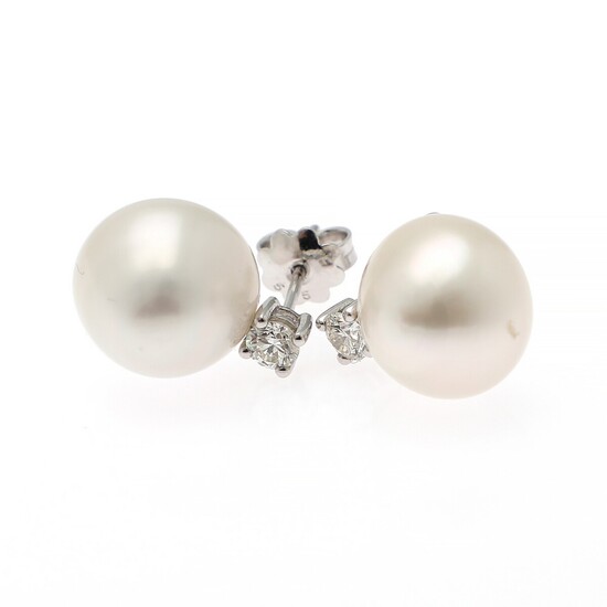 A pair of ear studs each set with a cultured freshwater pearl and a brilliant-cut diamond weighing a total of app. 0.50 ct., mounted in 14k white gold. (2)