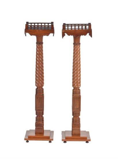 A pair of mahogany and brass strung torchere stands