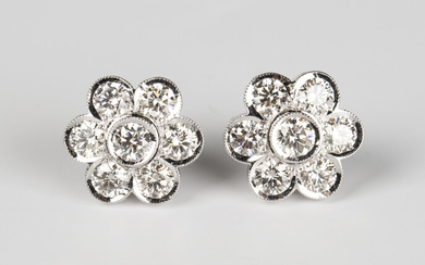 A pair of white gold and diamond floral cluster earrings, each collet set with seven circular cut di