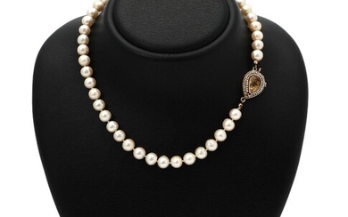 SOLD. A pearl of numerous cultured pearls and a clasp set with a pear-shapped citrine encircled by numerous cultured pearls, mounted in 14k gold. L. 42.5 cm. – Bruun Rasmussen Auctioneers of Fine Art
