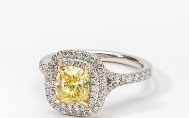 A platinum and fancy yellow diamond solitaire ring...