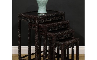 A set of Chinese hardwood quartetto tables, each carved thro...