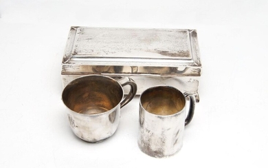 A silver cigarette box, Birmingham, c.1925, Joseph Gloster, of rectangular form with square bracket feet and wood-lined interior, together with a small Edwardian silver christening cup, Birmingham, c.1905, Joseph Gloster and a further silver cup...