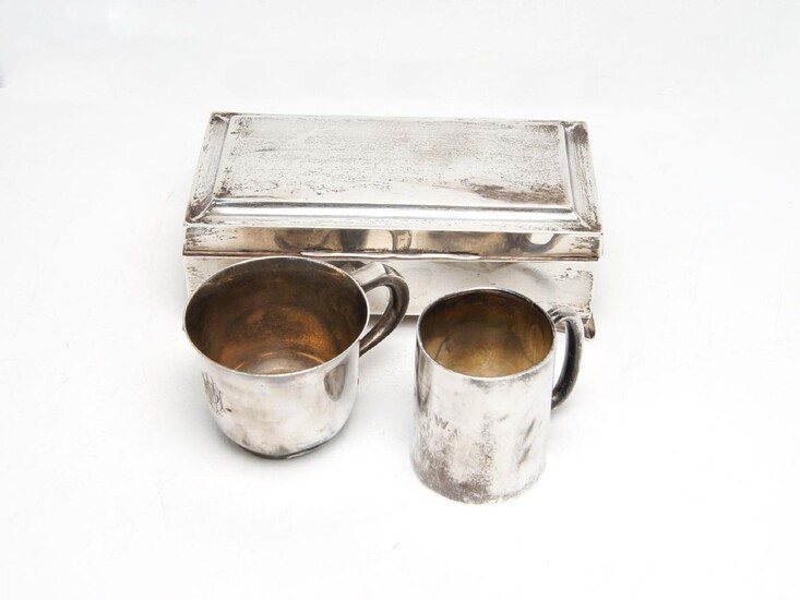 A silver cigarette box, Birmingham, c.1925, Joseph Gloster, of rectangular form with square bracket feet and wood-lined interior, together with a small Edwardian silver christening cup, Birmingham, c.1905, Joseph Gloster and a further silver cup...