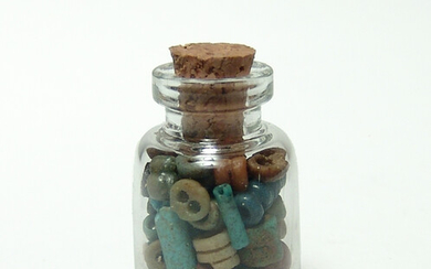 A small bottle filled with Egyptian faience beads