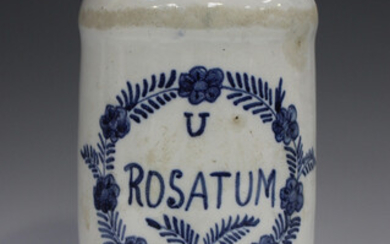 A tin glazed cylindrical dry drug jar, 19th century, inscribed in blue 'U Rosatum' within