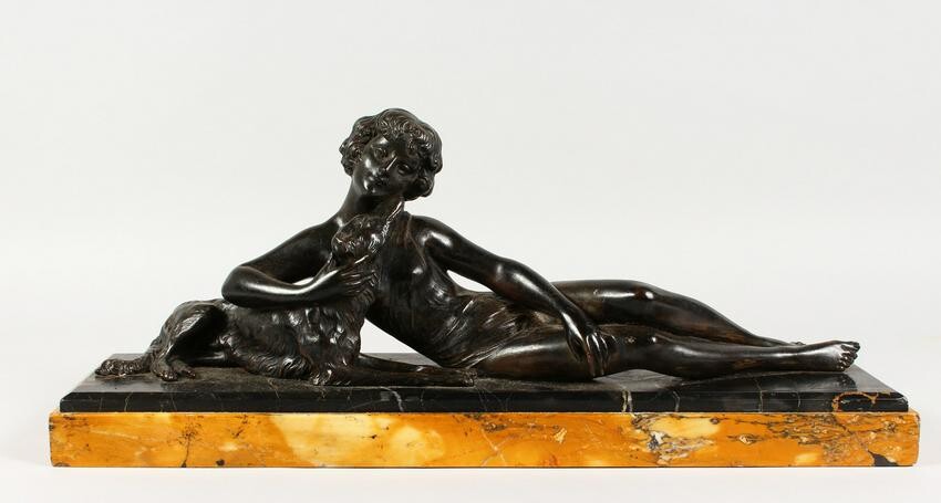 AN ART DECO PATINATED SPELTER GROUP, of a reclining
