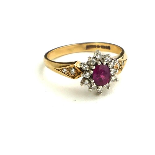 AN EARLY/MID 20TH CENTURY 9CT GOLD RING SET WITH A RUBY SURR...