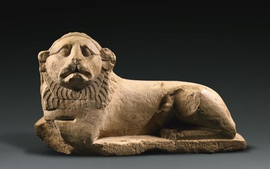 AN EGYPTIAN INDURATED LIMESTONE FIGURE OF A LION, PTOLEMAIC PERIOD, LAST QUARTER OF THE 3RD CENTURY B.C.