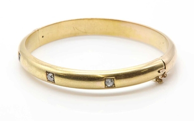 An Edwardian diamond set hollow hinged bangle