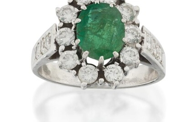 An emerald and diamond cluster ring, centring on an oval mixed-cut emerald framed by brilliant-cut diamonds, French assay mark, approx. ring size M