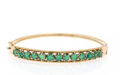 An emerald bangle set with numerous circular-cut emeralds, mounted in 14k gold. Diam. 5.6 cm. Weight app. 7,5 g.