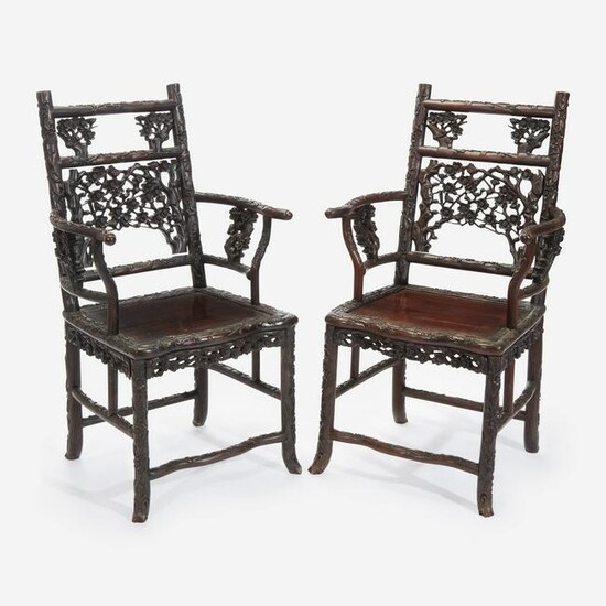 An unusual pair of Chinese carved hardwood armchairs