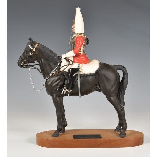 Beswick Porcelain Life guard on Horseback, on a wooden stand...