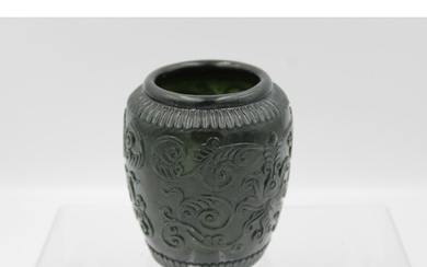 Chinese green jade bowl adorned with floral patterns through...
