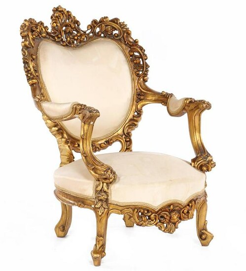 Classic gold-colored armchair with rich stitching