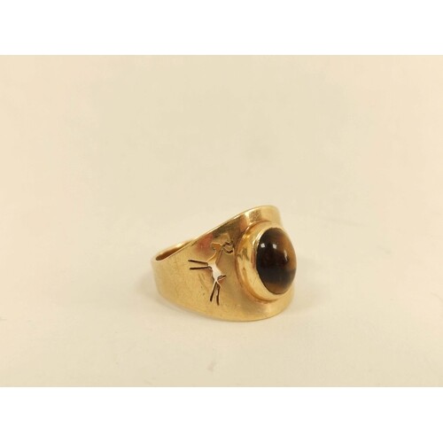 Gold ring with tigers eye cabochon and pierced gazelle shoul...