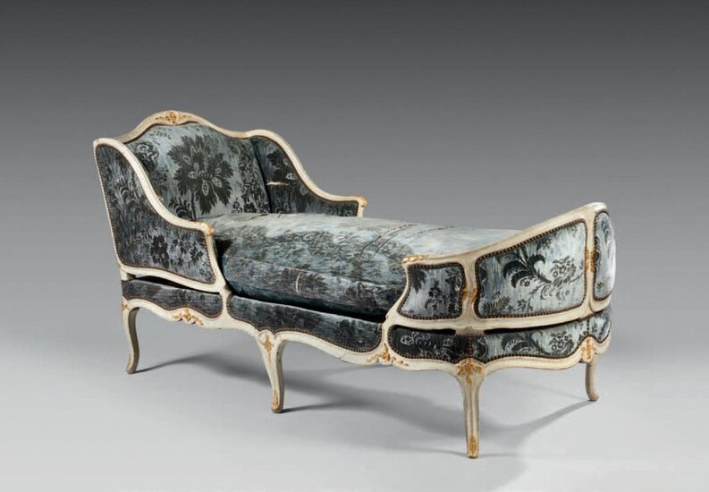 Moulded and carved beech deckchair, relaqued and gilded, decorated with foliage, blue silk cover with flower pattern.