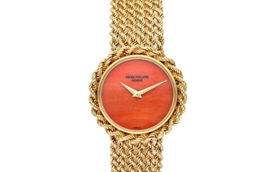 Patek Philippe Reference 4282 1 | A yellow gold bracelet watch with coral dial, Circa 1975