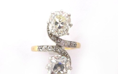 RING TOI ET MOI in 18K yellow and white gold holding two cushion cut diamonds of approximately 1.10 carat followed by a line of 8/8 diamonds. French work. Gross weight : 4,47 gr. A diamond and yellow gold ring.