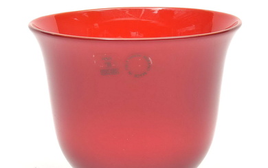 Red glass bowl on black base, executed by...