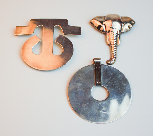 THREE CONTEMPORARY MEXICAN STERLING SILVER PENDANTS. One discular with wooden...