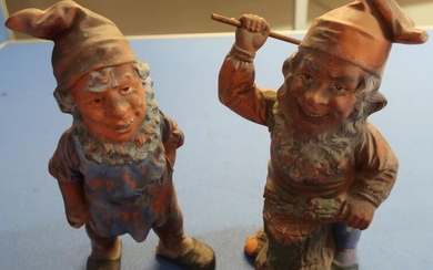 Two painted terracotta garden gnomes, one as an axe-man,...