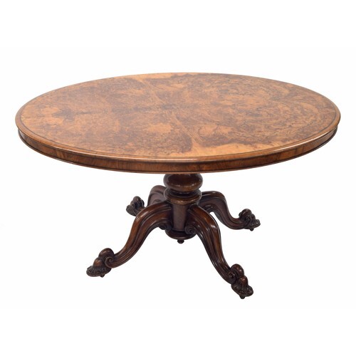 Victorian oval walnut loo table, the figured moulded tilting...