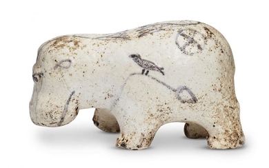 An Egyptian white glazed painted limestone hippopotamus,...