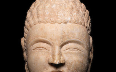 A white marble head of Buddha
